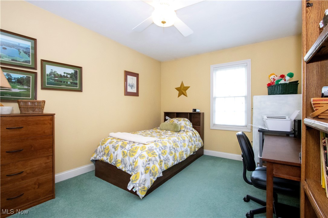 10050 Mennonite Road Rittman, OH 44270 - Photo 23 of 42 Bedroom with dark colored carpet, a desk, baseboards, and ceiling fan