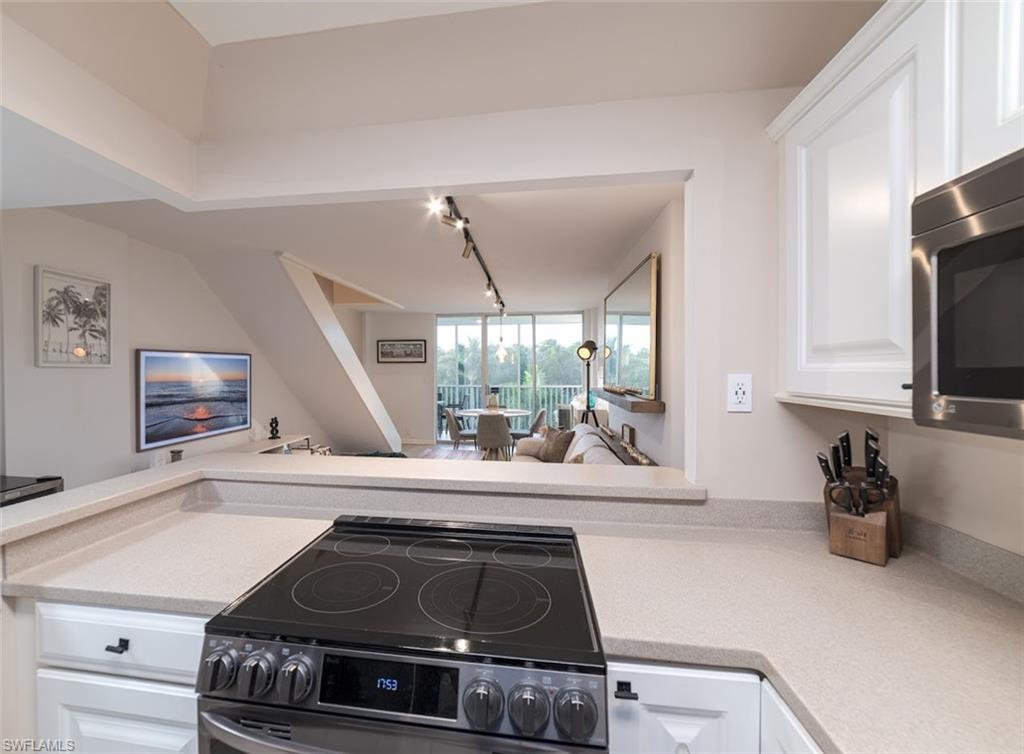5 Bluebill Avenue, Unit 305 405 Naples, FL 34108 - Photo 14 of 30 a kitchen with a stove and a sink
