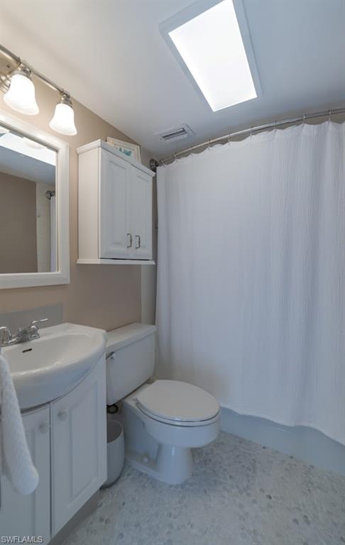 5 Bluebill Avenue, Unit 305 405 Naples, FL 34108 - Photo 16 of 30 a bathroom with a toilet a sink and mirror
