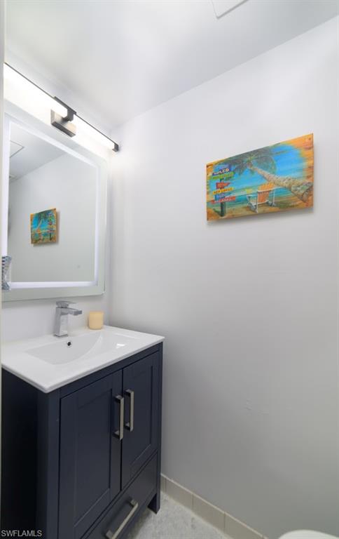 5 Bluebill Avenue, Unit 305 405 Naples, FL 34108 - Photo 17 of 30 a bathroom with a sink mirror and vanity