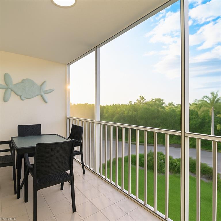 5 Bluebill Avenue, Unit 305 405 Naples, FL 34108 - Photo 18 of 30 a view of a balcony dining table and chairs