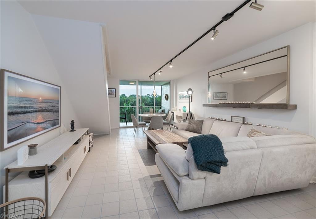 5 Bluebill Avenue, Unit 305 405 Naples, FL 34108 - Photo 3 of 30 a living room with furniture and a flat screen tv