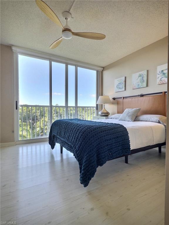 5 Bluebill Avenue, Unit 305 405 Naples, FL 34108 - Photo 7 of 30 a bedroom with a large bed and a large window