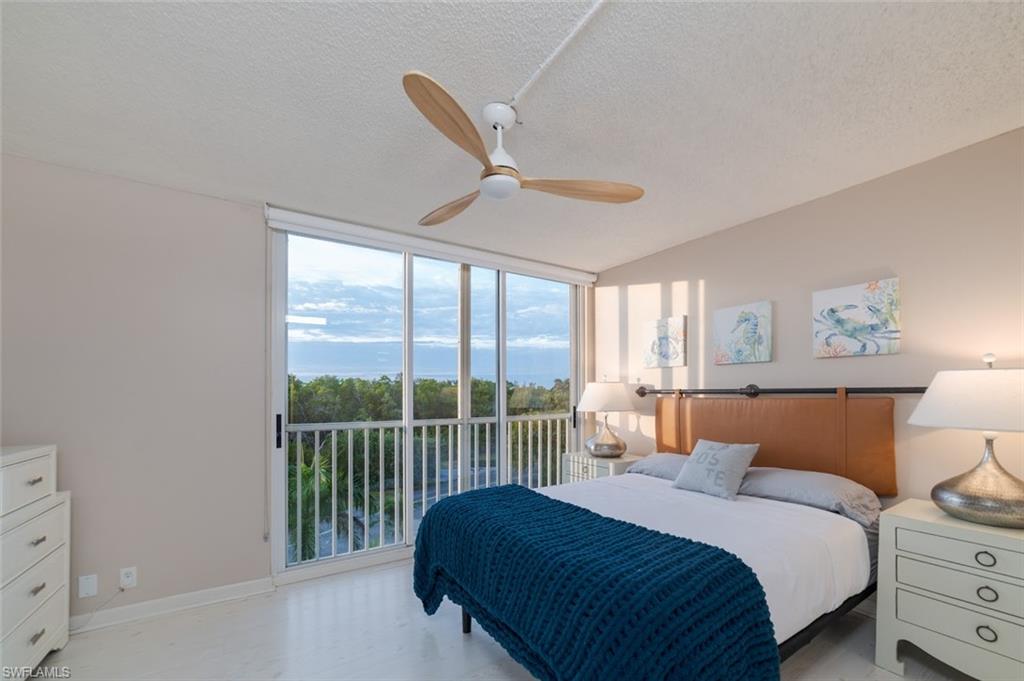 5 Bluebill Avenue, Unit 305 405 Naples, FL 34108 - Photo 9 of 30 a bedroom with a large bed and a window
