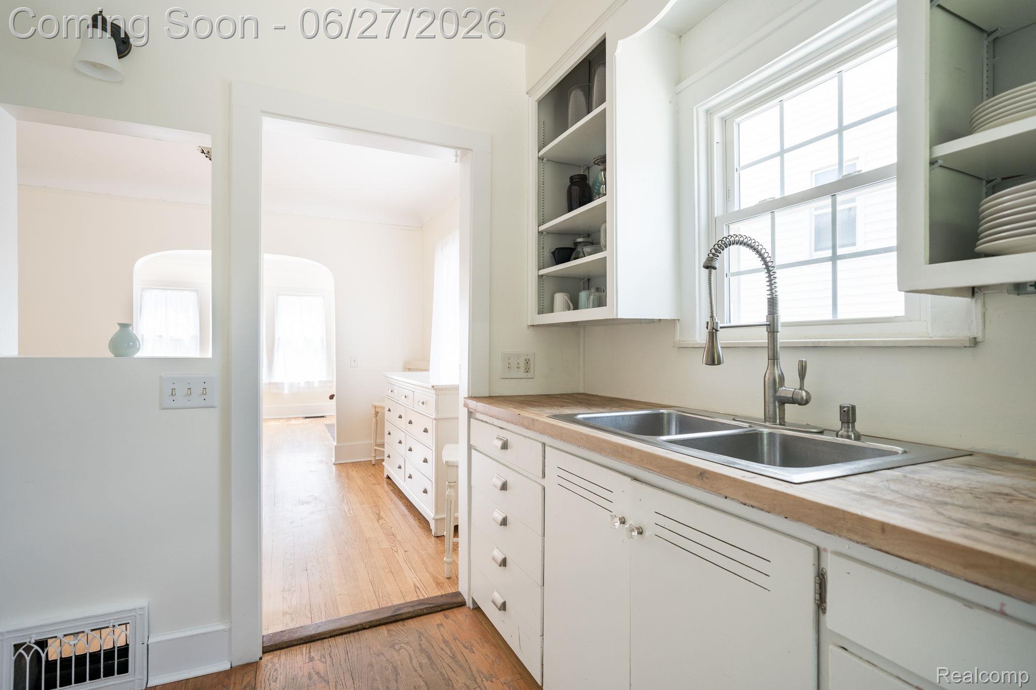 39 Mohawk Road Pontiac, MI 48341 - Photo 4 of 32 Kitchen area with a double basin stainless steel sink, wood-finish countertops, and white cabinetry