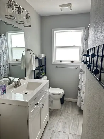 a bathroom with a toilet sink and mirror