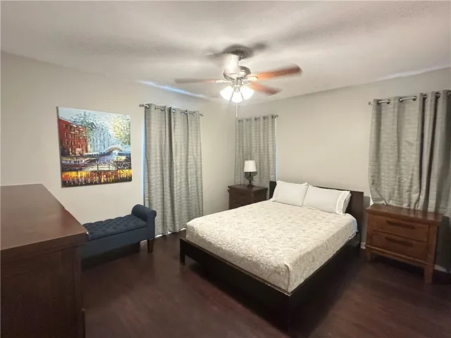 a bedroom with a bed lamp and a window