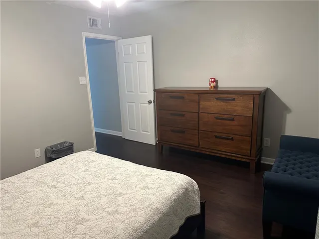 a bedroom with a bed and cabinets