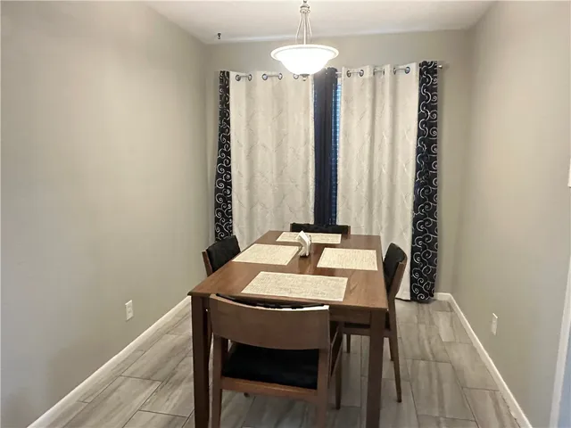 a view of a dining room with furniture and chandelier