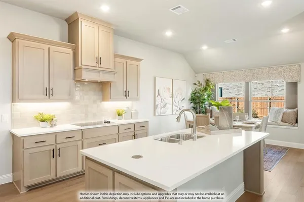 a kitchen with kitchen island sink stove and white cabinets