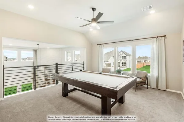 a room with pool table and windows