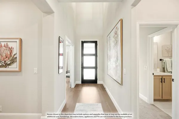 a view of a hallway with windows and entryway