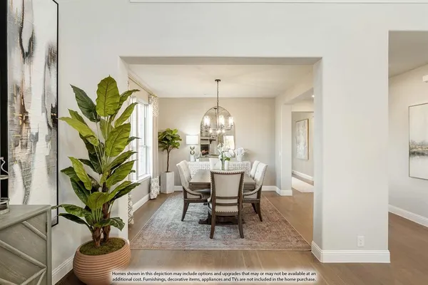a dining room with furniture a rug and a chandelier