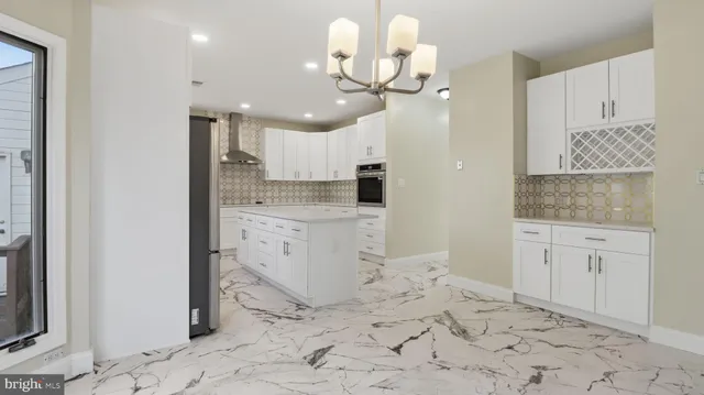 a kitchen with stainless steel appliances a refrigerator sink and microwave