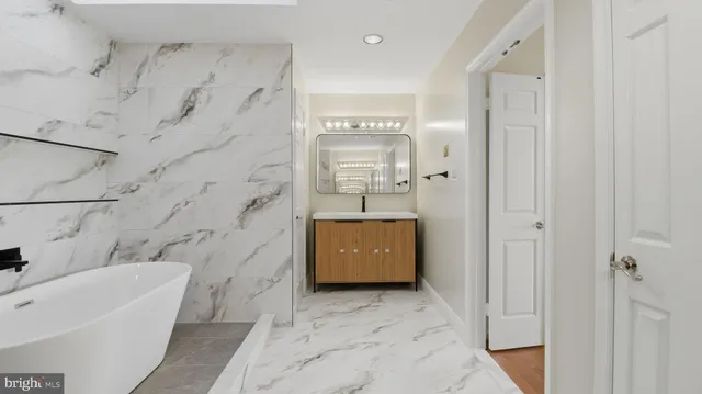 a bathroom with a bathtub and a sink