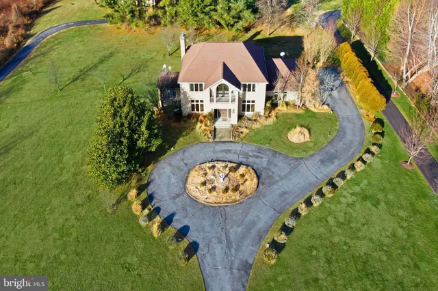 an aerial view of a house with swimming pool and outdoor space