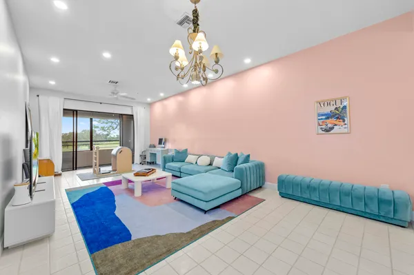 a living room with furniture and a chandelier