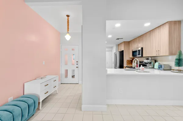 a kitchen with stainless steel appliances a refrigerator sink and cabinets