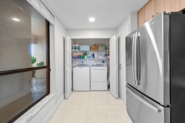 a kitchen with stainless steel appliances kitchen island sink refrigerator and stove