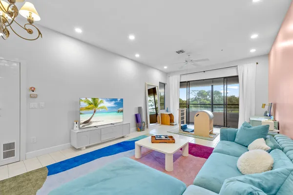 a living room with furniture and a chandelier