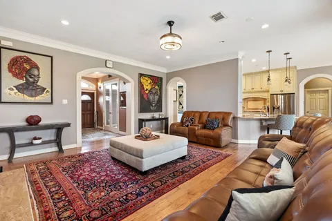 a living room with furniture and a chandelier
