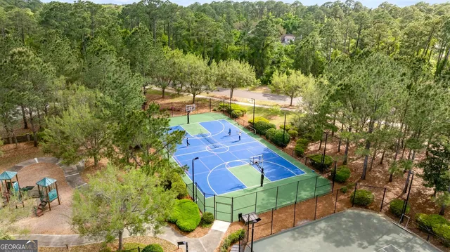 a sign that is sitting in front of a tree