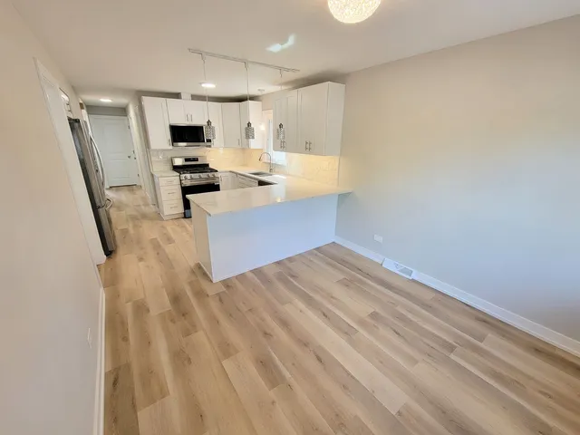 a kitchen with a refrigerator counter top space and a sink