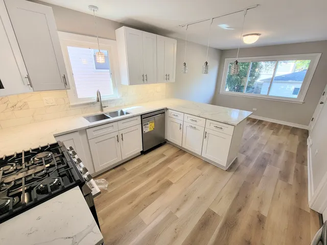 a kitchen with a sink stove and cabinets