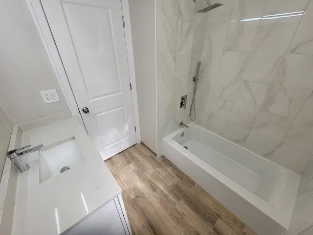 a bathroom with a bathtub and shower