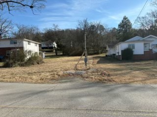 a backyard of a house with large trees