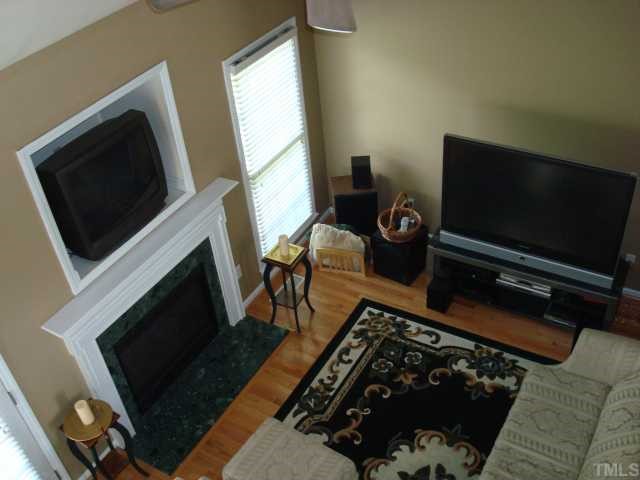 5017 Amberfield Way Raleigh, NC 27604 - Photo 4 of 10 a living room with a flat screen tv and a fireplace