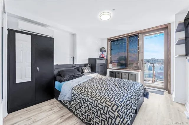 a bedroom with a bed and a large window