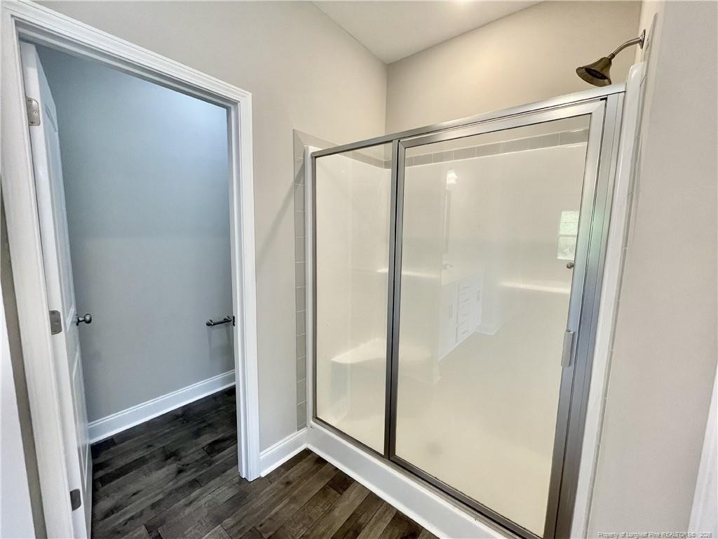 5177 Maxwell Road Stedman, NC 28391 - Photo 12 of 24 a bathroom with a glass shower door and mirror