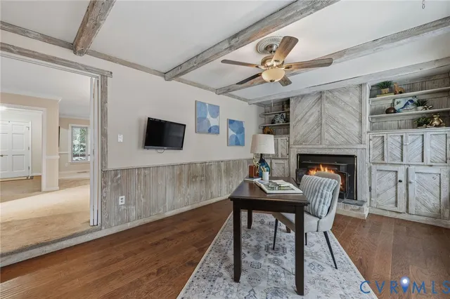 a bathroom with a granite countertop sink a mirror a toilet and a window