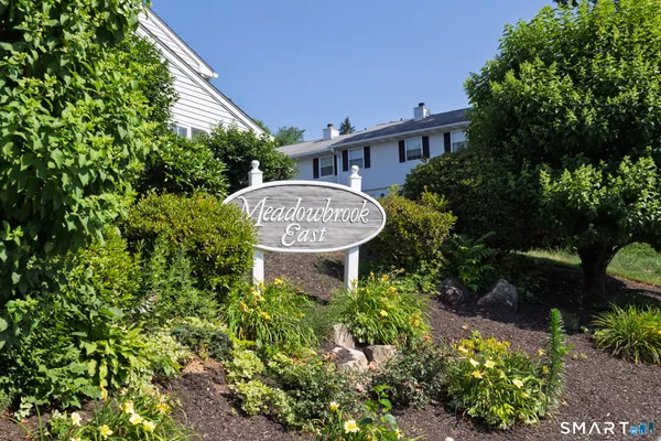 a view of a house with a backyard and garden