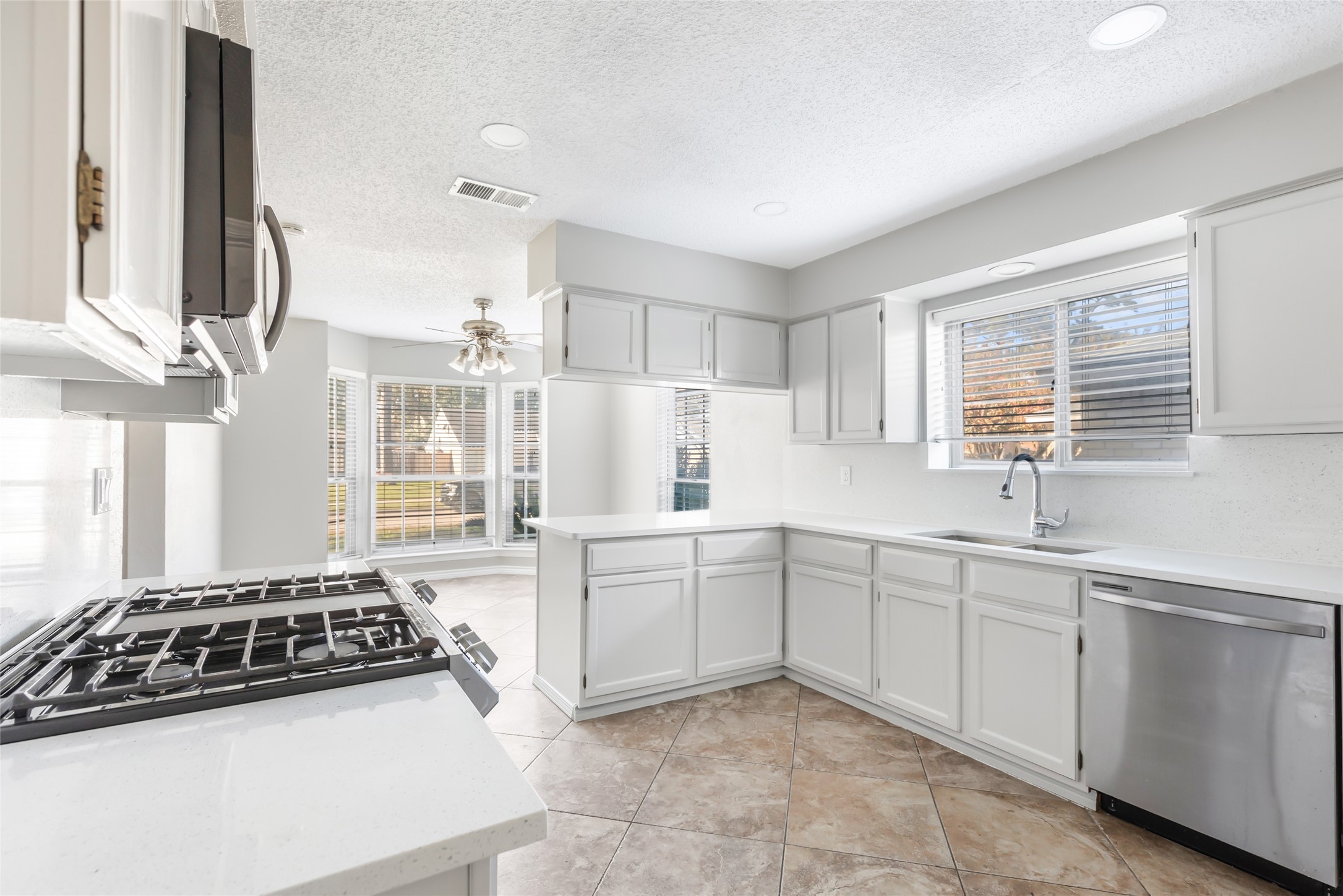 18910 Yaupon Trail Humble, TX 77346 - Photo 8 of 22 Kitchen with recessed lighting, stainless steel appliances, quartz countertops and refreshed cabinetry