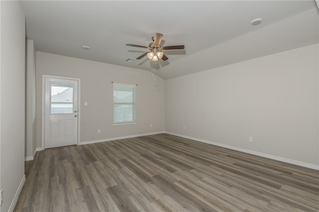 2166 Chief Street Bryan, TX 77807 - Photo 9 of 18 wooden floor in an empty room with a window