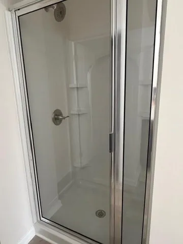 a view of a room with window and hardwood floor