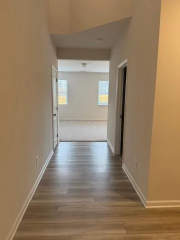 a view of a hallway with wooden floor