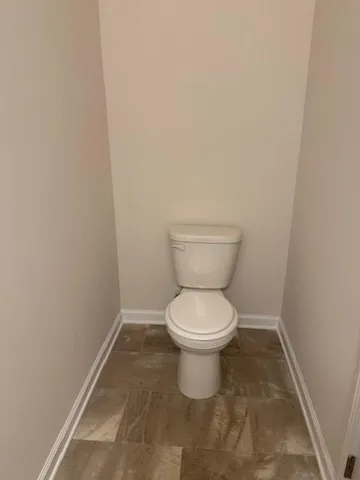 a white toilet sitting in a bathroom