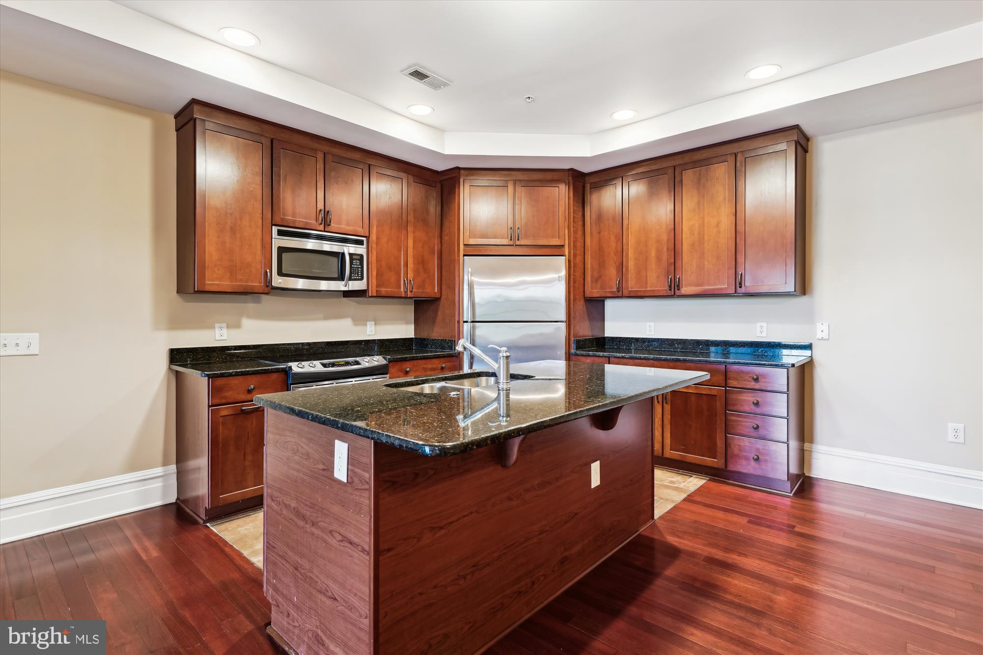 9610 Dewitt Drive, Unit PH410 Silver Spring, MD 20910 - Photo 8 of 64 a kitchen with stainless steel appliances granite countertop wooden cabinets a sink and a stove