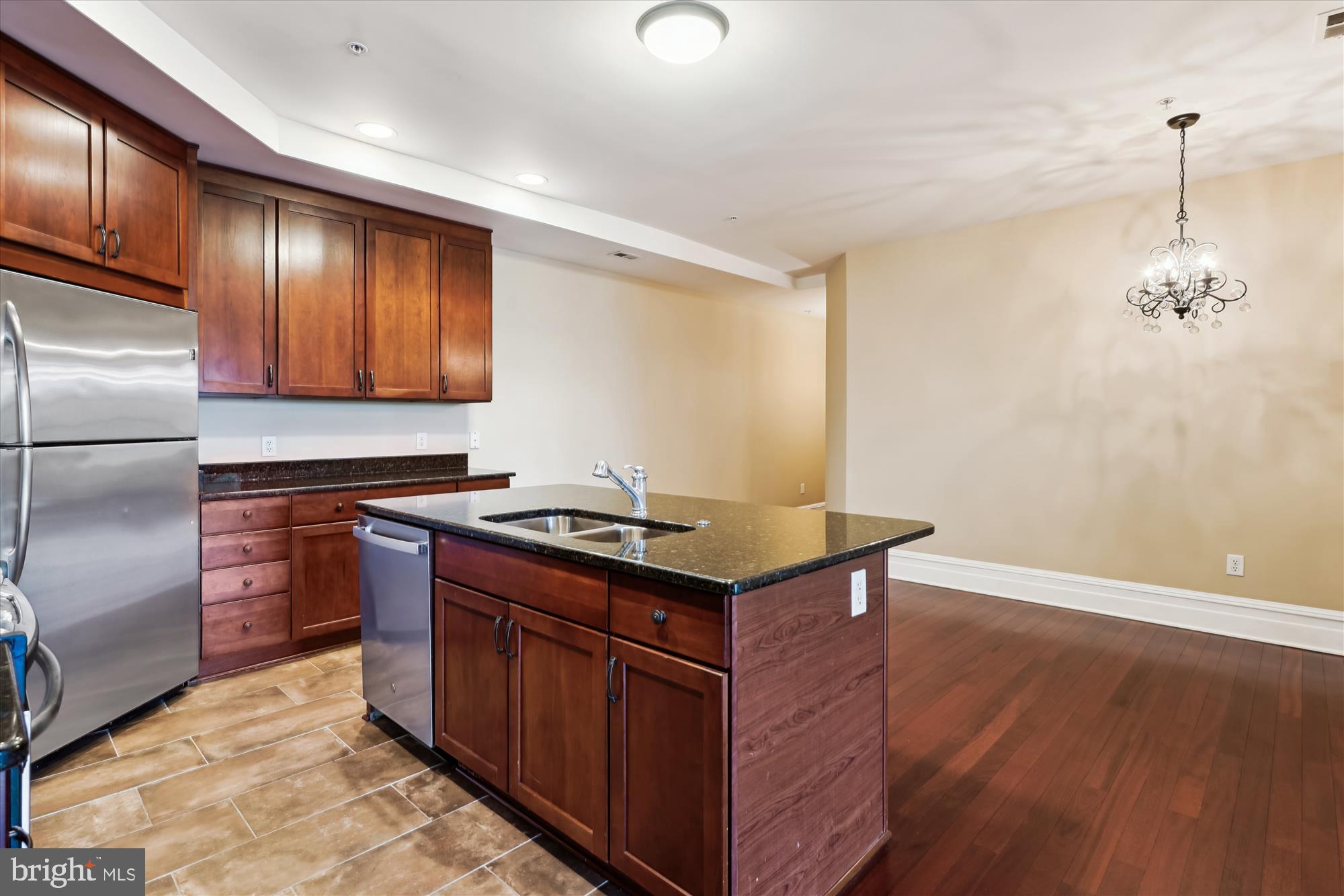 9610 Dewitt Drive, Unit PH410 Silver Spring, MD 20910 - Photo 9 of 64 a kitchen with stainless steel appliances granite countertop a stove a refrigerator and a microwave