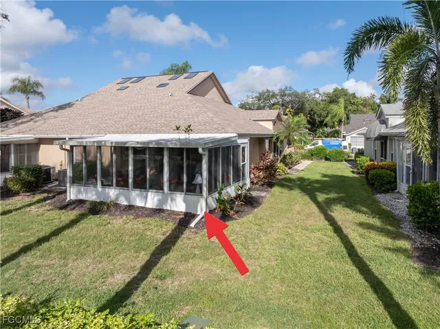 a front view of a house with a garden and trees