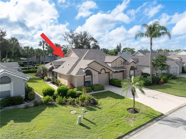 a front view of a house with a garden and yard