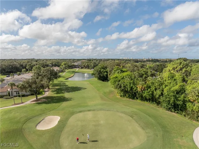 a tennis court with view of trees in the background