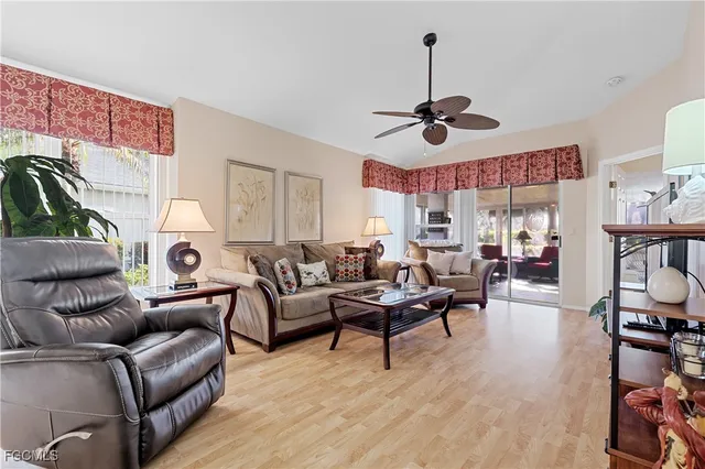 a living room with furniture a ceiling fan and a rug