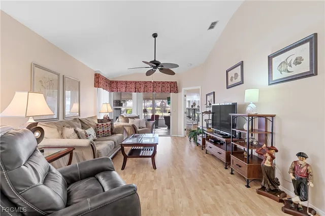 a living room with furniture a window and a flat screen tv