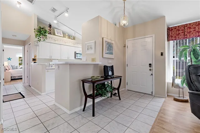 a kitchen with stainless steel appliances granite countertop a sink and a refrigerator
