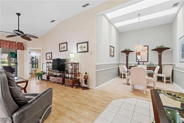 a living room with furniture a flat screen tv and gym equipment