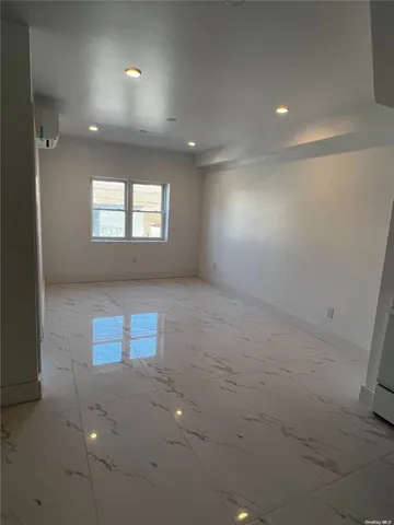 an empty room with windows and entrance